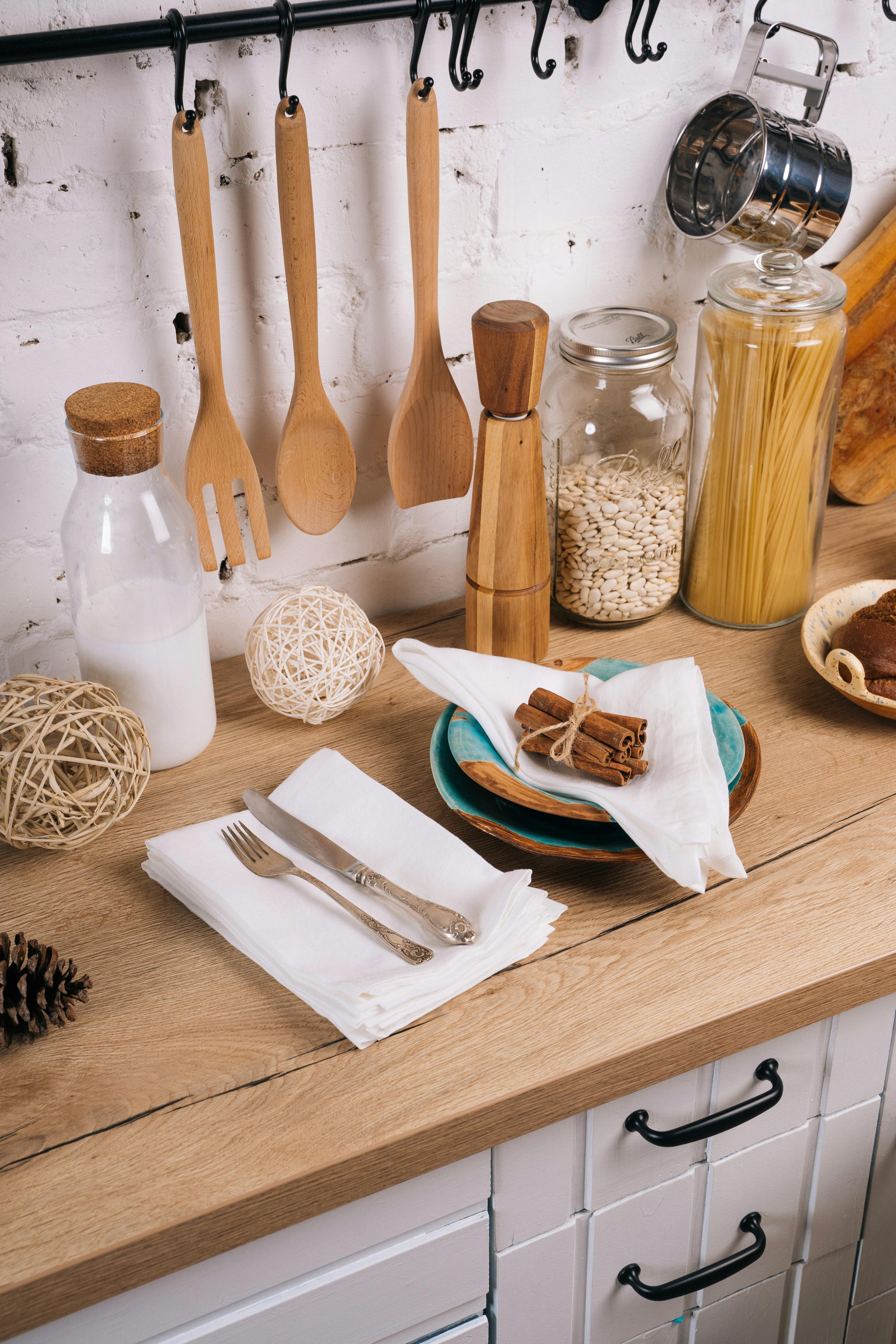 Kitchen Utility — wooden utensils cutlery and serveware on rustic counter